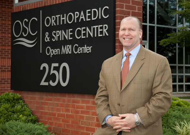 Dr. Carlson with OSC Sign