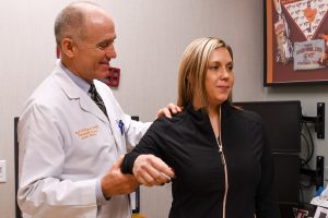 Image of Dr. Boyd Haynes examining a patient