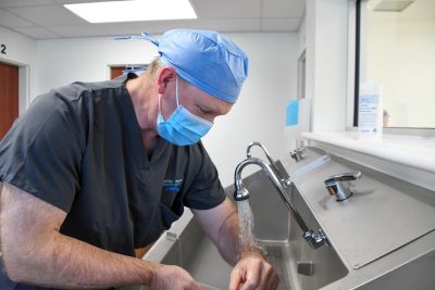 Dr. Carlson scrubbing for surgery